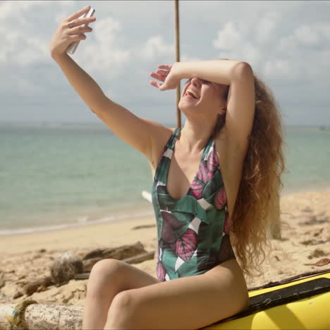 attractive woman taking selfie on beach