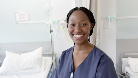 Portrait-of-happy-african-american-female-doctor-in-hospital-room,-slow-motion