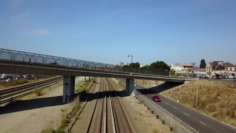 Train-cruising-under-freeway-california