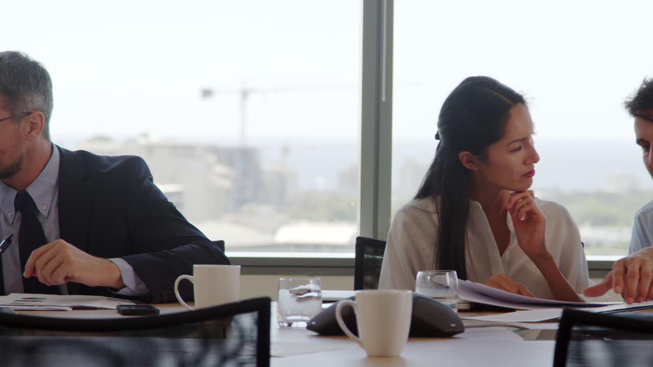 Tracking Shot Of Businesspeople Meeting In Boardroom