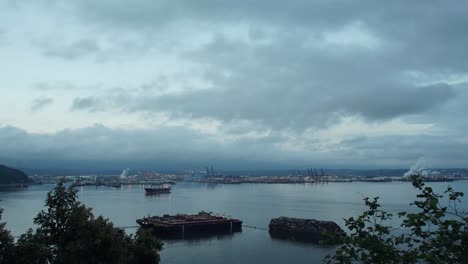 Time-Lapse-of-a-cloudy-sunrise-over-the-Port-of-Tacoma,-Washington