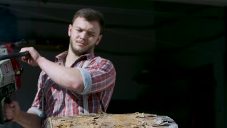 lumberjack cutting wood with chainsaw