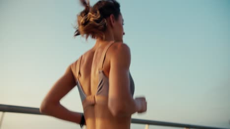 close-up shot of a young athletic girl in sportswear running down the street in the morning. morning running