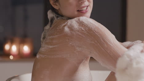 Side-View-Of-A-Woman-Taking-A-Bath-While-Rubbing-Her-Back-And-Arms-With-Soap-1