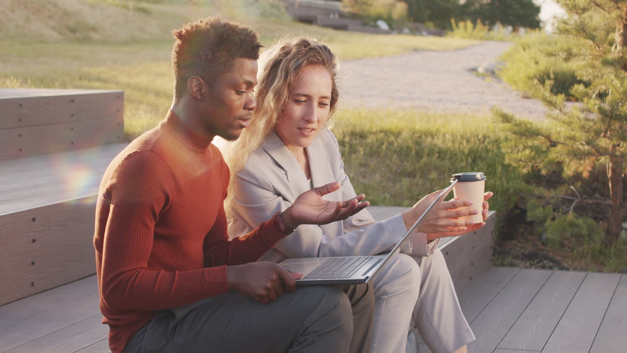 Business Couple Working on Laptop in Park