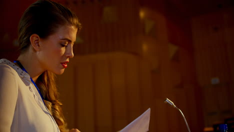 Young-Caucasian-businesswoman-practicing-speech-in-empty-auditorium-4k