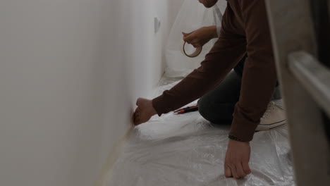 couple preparing walls for painting