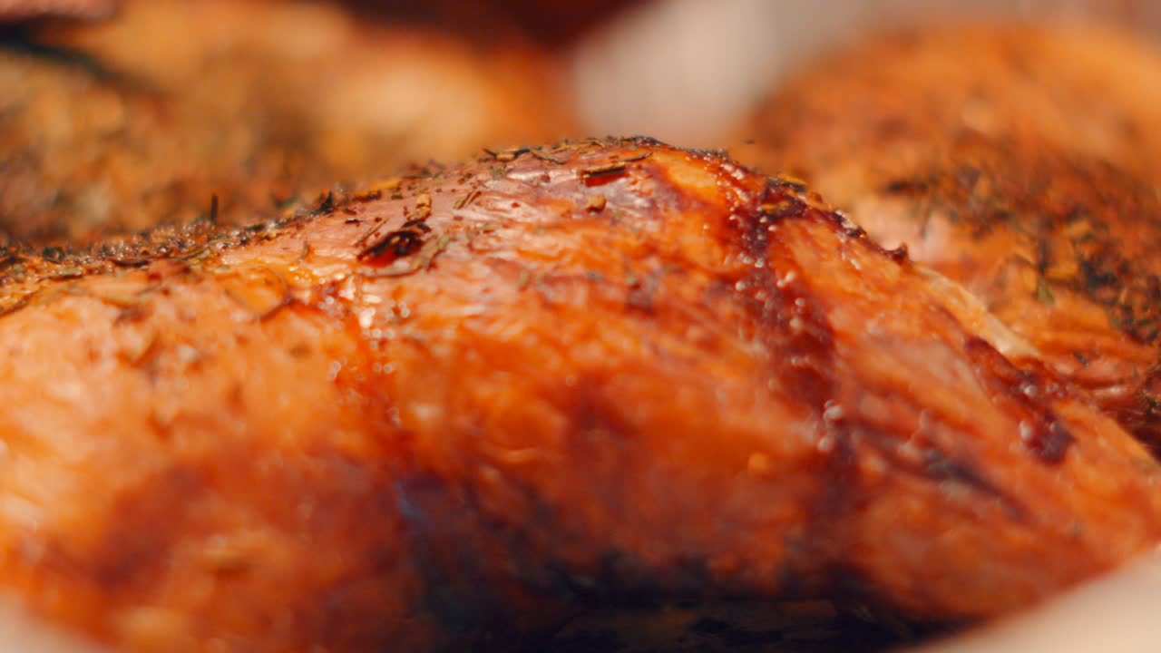 Slow Pan Across Crispy Skin Chicken Leg with Thyme Seasoning and Shallow Depth fo Field. Roasted Bird Ready to Eat. Classic British Cuisine Food