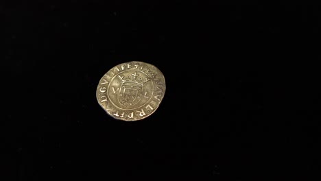 old silver coin in black background