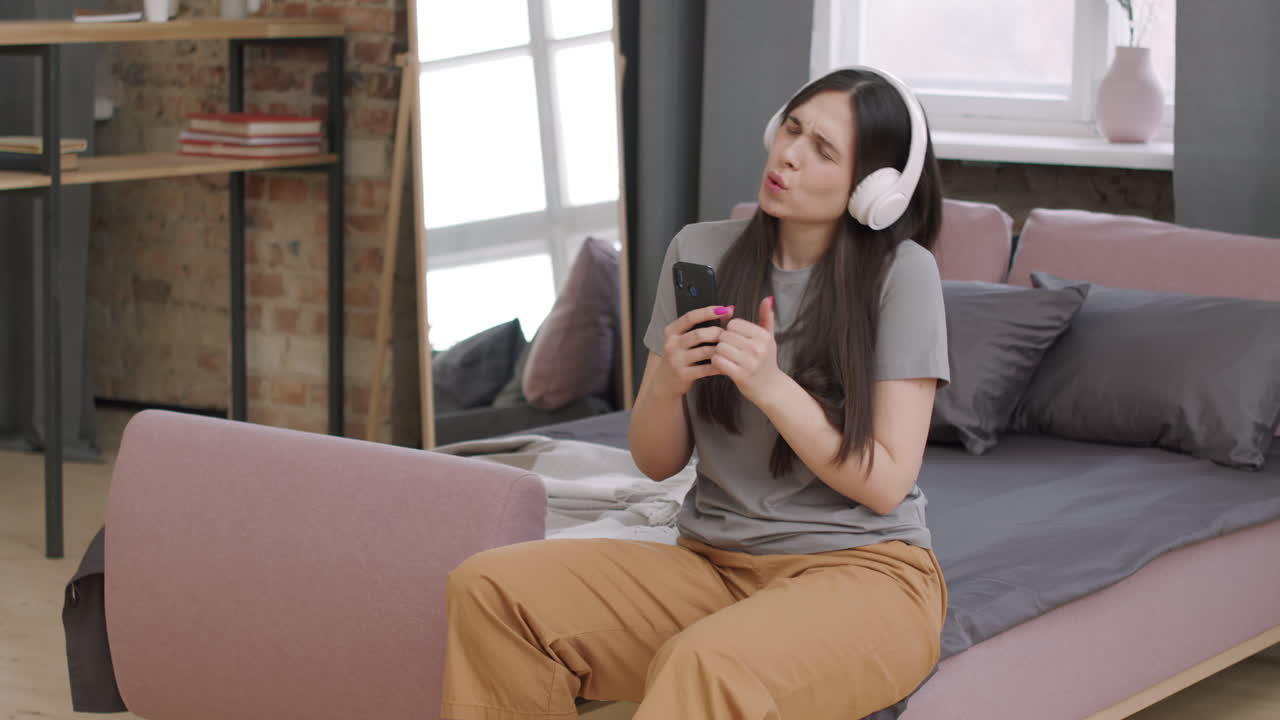 Young Woman in Headphones Enjoying Music
