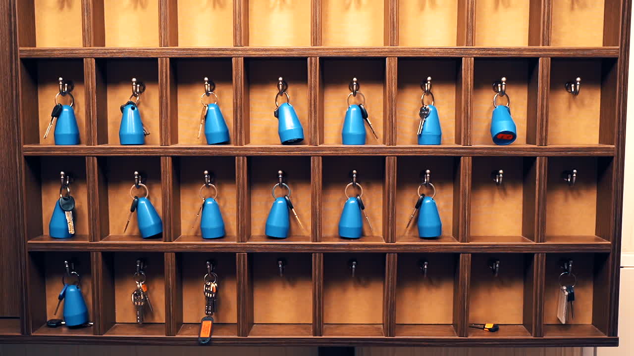 Rooms keys at hostel reception. Hotel keys with room numbers hanging at reception desk counter