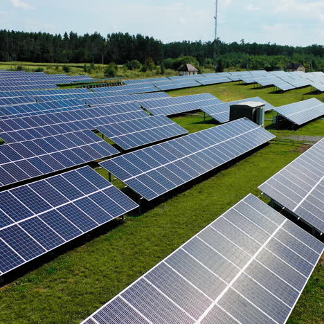 flight near blue solar batteries in the field. contemporary electricity farm of alternative source of energy. innovative ecological power plant.
