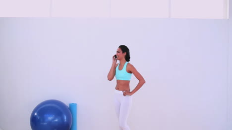 fit woman talking on her phone and leaving