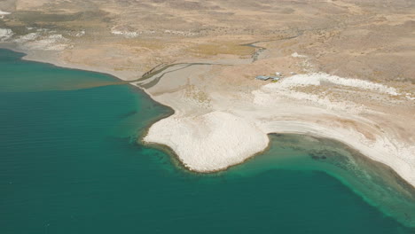 Stunning-aerial-view-of-the-rocky-beach-at-Lake-Strobel,-Argentina