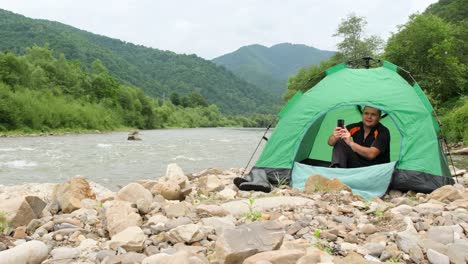 man camping by the river