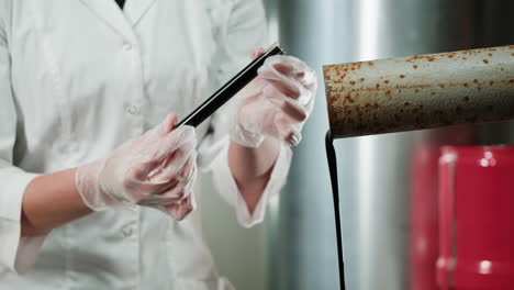 scientist analyzing oil sample in a laboratory setting