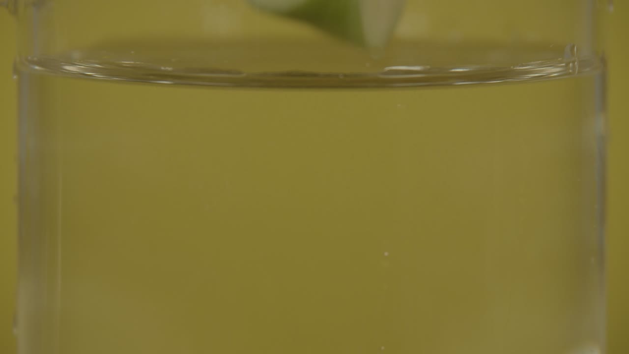 Apple slice drops into water in SLOW MOTION