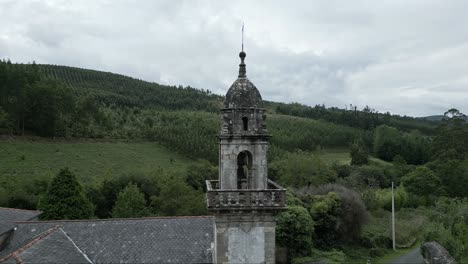 aerial pan shot of moeche church built in the 15th century in the ferrol region, galicia, spain