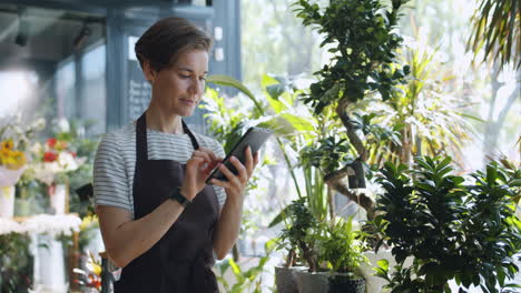 florist using tablet in shop