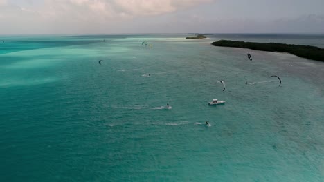 kitesurf competition sport many colourful kites on caribbean sea water, los roques