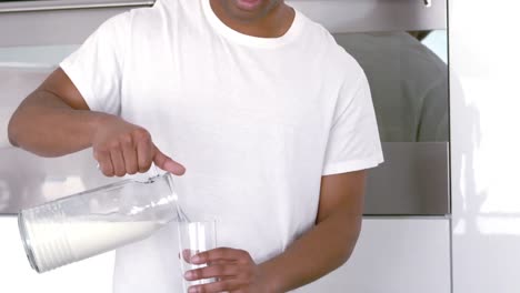 smiling man serving a glass of water