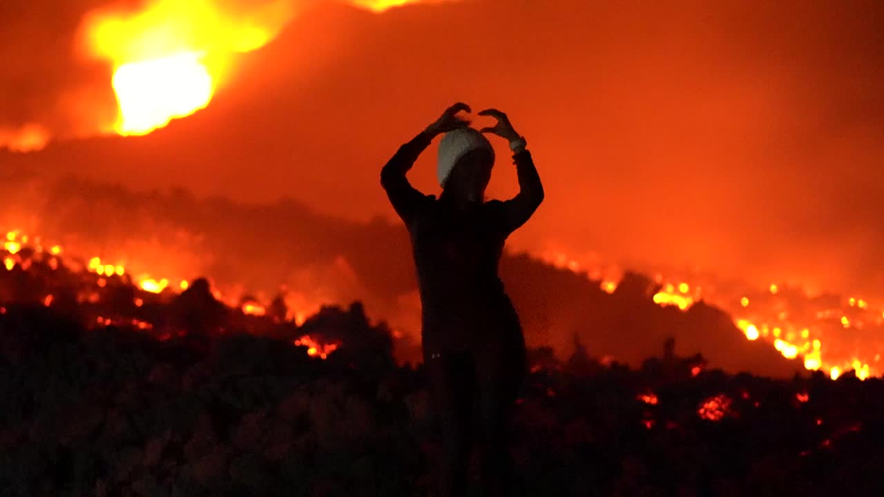 Woman cellebrates her victory. Woman dancing on top of volcano