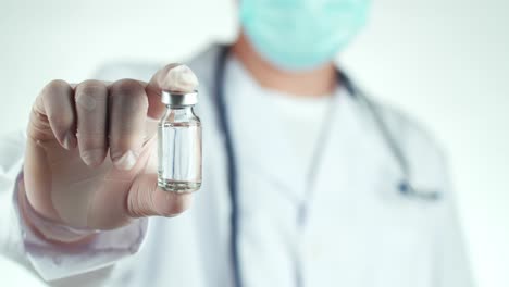 doctor holding a vaccine vial
