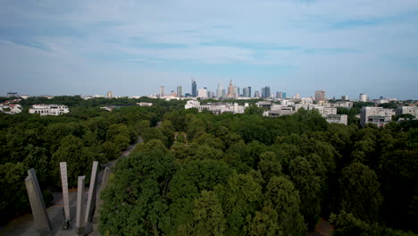 aerial of warsaw with buildings of the city centre over the forest