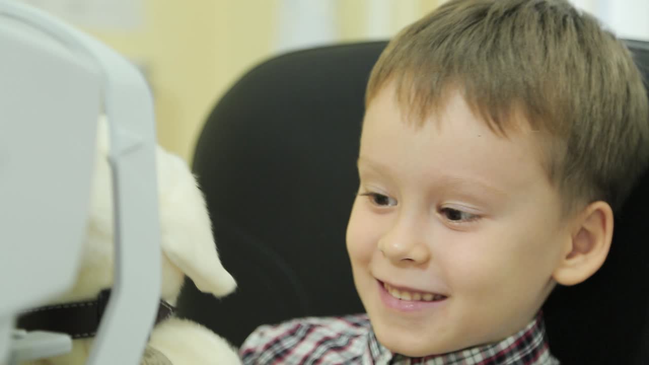 Little boy checks eyesight. Ophthalmologist measuring intraocular pressure of patient in clinic
