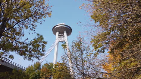 pylon and ufo structure of snp bridge in bratislava, slovakia on sunny autumn day, low angle view from park