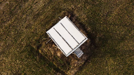 Wooden-hunting-tower-in-aerial-ascending-shot