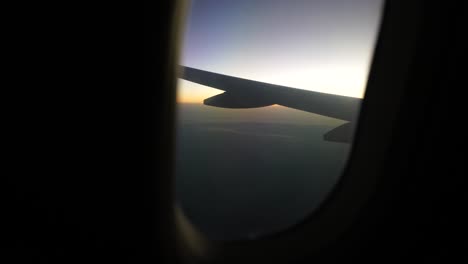 the horizon during sunset, seen through an airplane's window