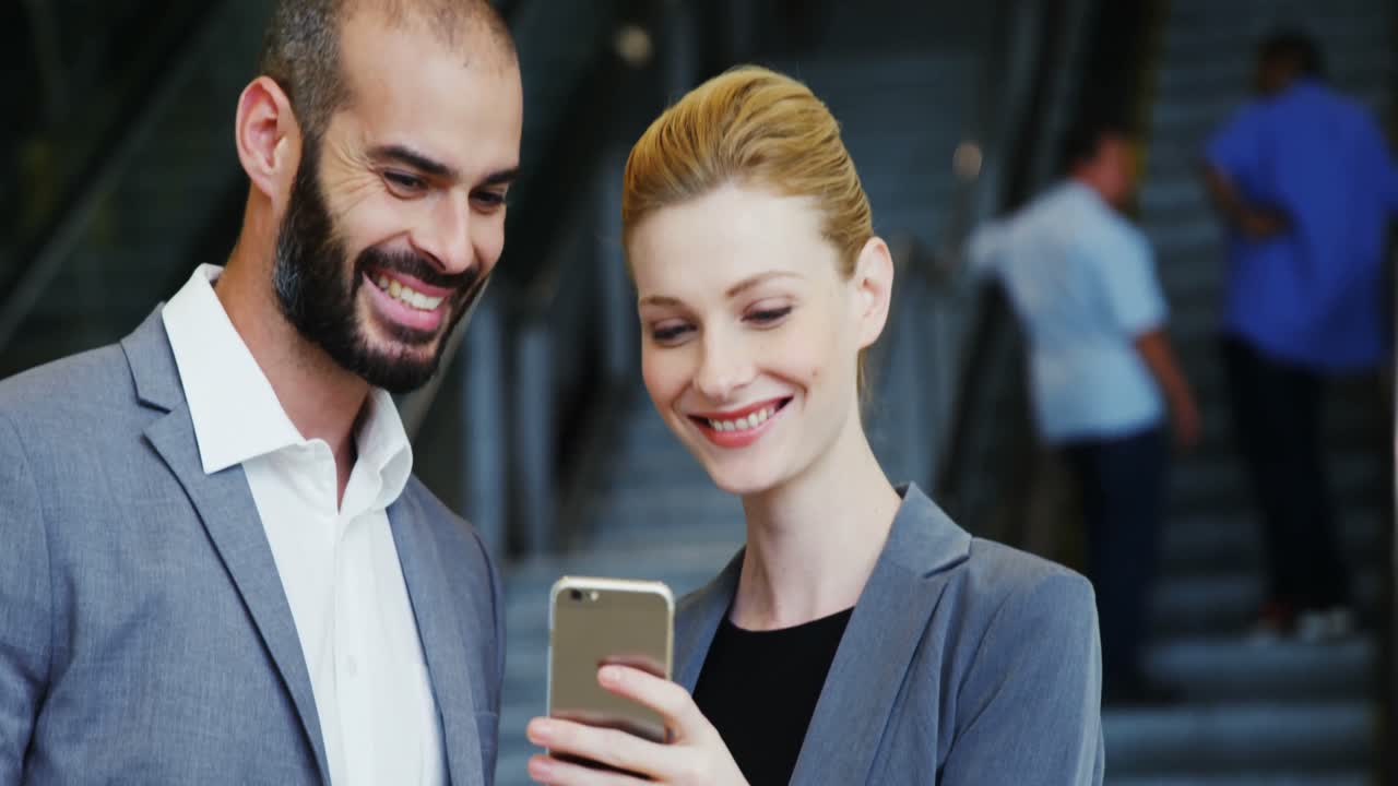 Business people looking at smartphone