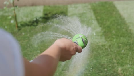 man laying sod grass in backyard garden for lawn installation and landscaping project, focused on home improvement and outdoor maintenance for a fresh, green lawn in a residential yard