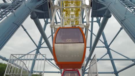 ferris wheel shot against the clouds and overcast sky. warm colors, daylight.