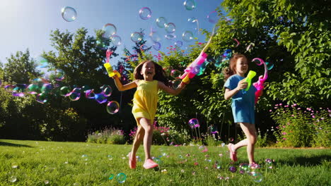 two young girls joyfully playing with bubbles in a sunny park