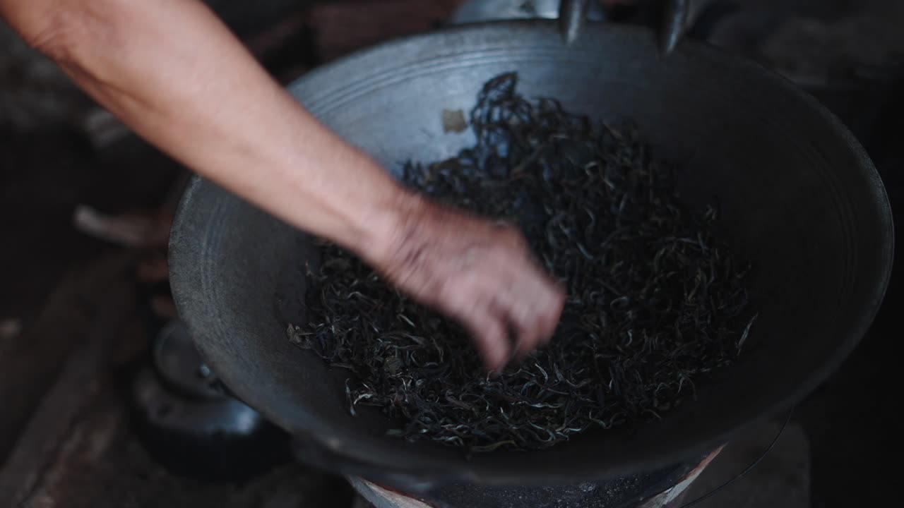 Tea Leaves Being Stirred in a Pan