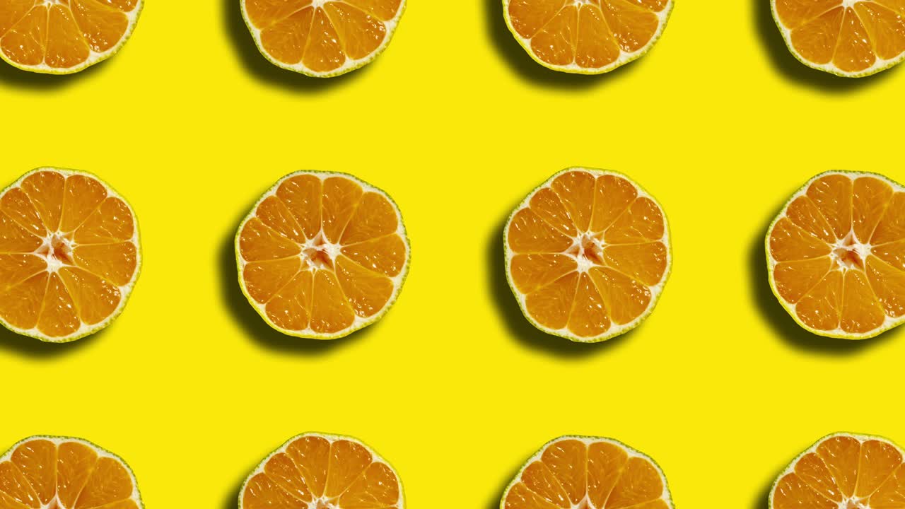 patrón geométrico mandarín en un fondo amarillo. gráficos de movimiento simples animación de frutas de la naturaleza