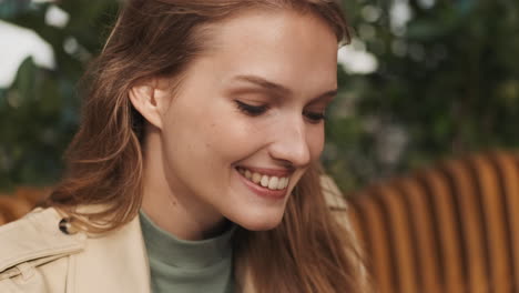 caucasian female student smiling outdoors.