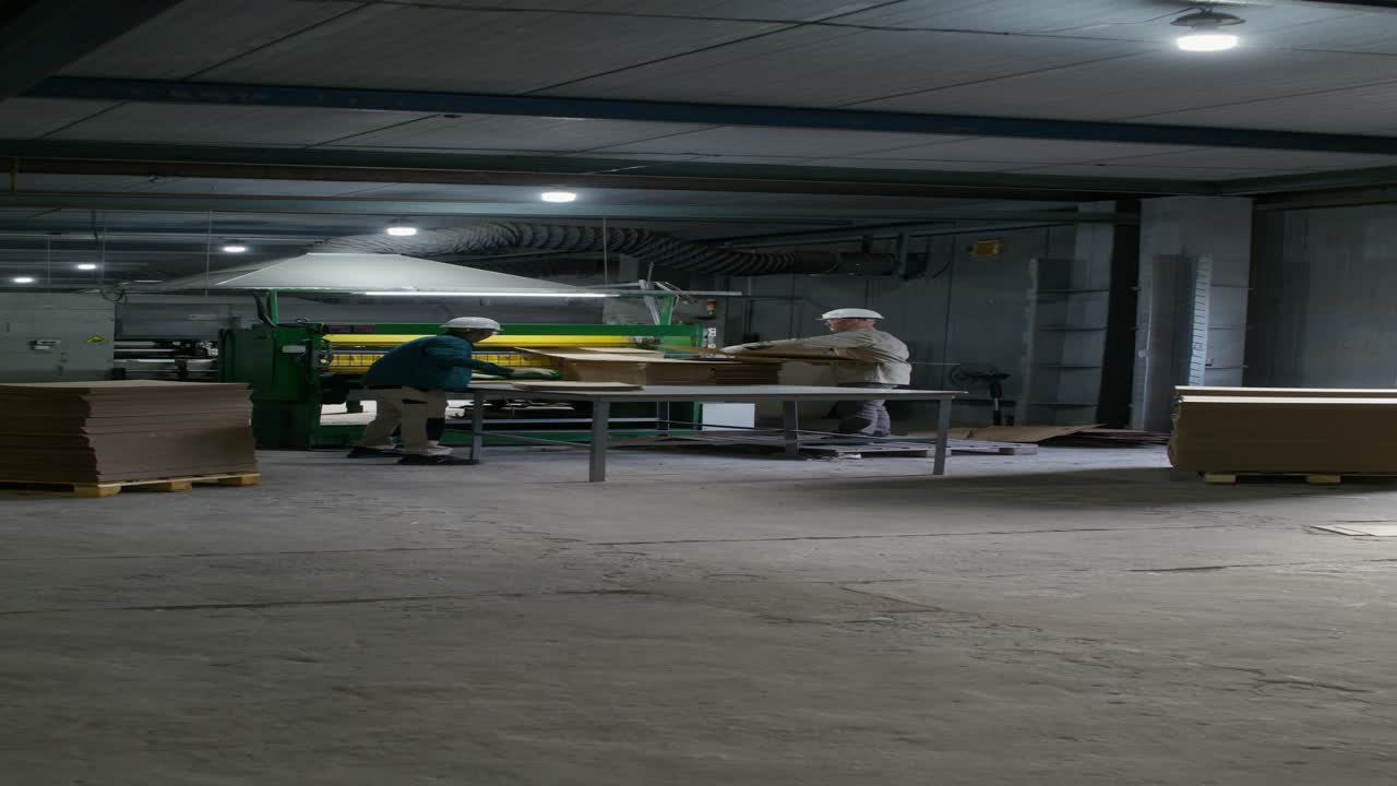 Factory Workers Packaging Cardboard Boxes