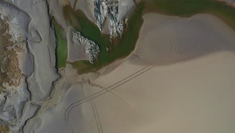 aerial top down view of the coast line in the uk, with the tide out, on summers day