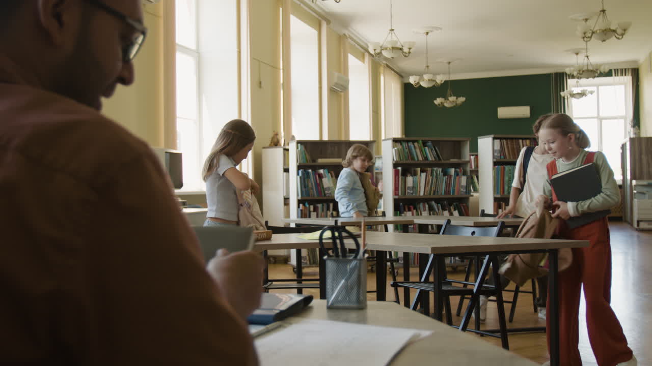 Children and Teacher in a School Library: Learning and Positive Interactions