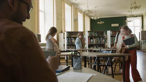 children and teacher in a school library: learning and positive interactions
