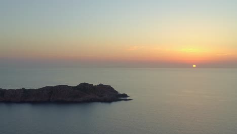 rocky cliff located in blue ocean