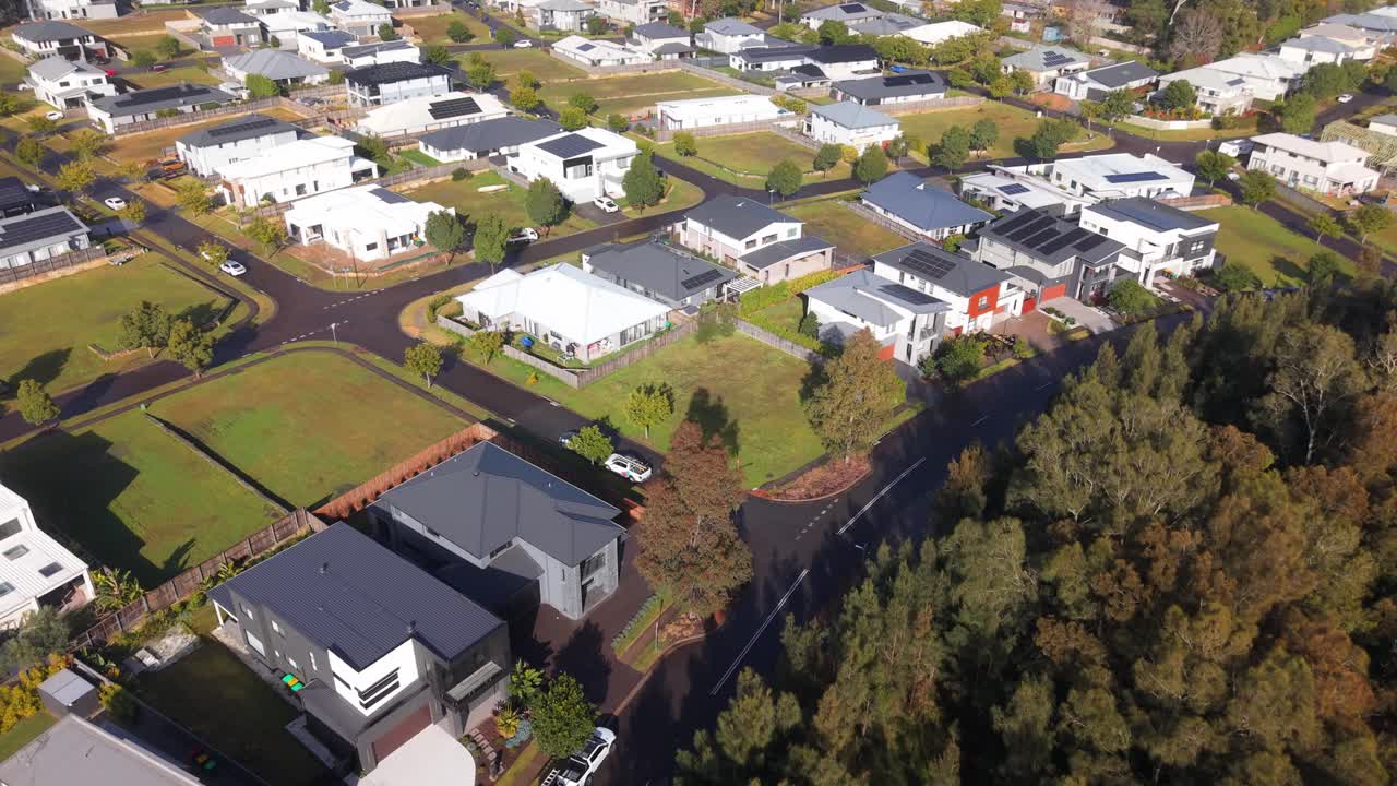 Aerial establishing of Trinity Point homes and marina near shoreline in Morisset NSW, suburban neighborhood with large lawns