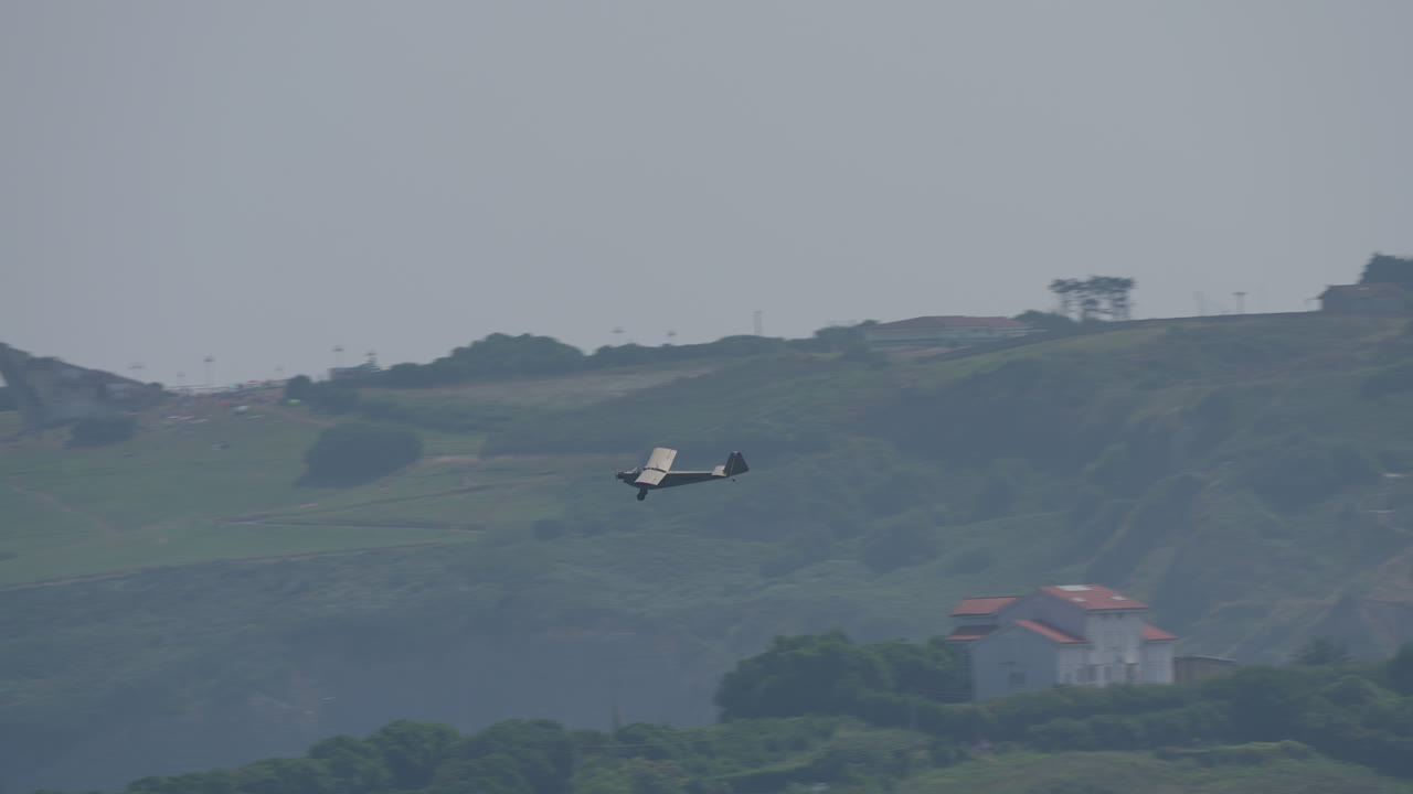 Aeroplane flying over a hilly landscape