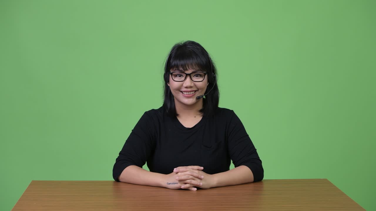 Beautiful Asian businesswoman working as call center representative