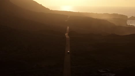 drone flies forward along volcanic road at sunset, tranquil landscape, spain, 4k