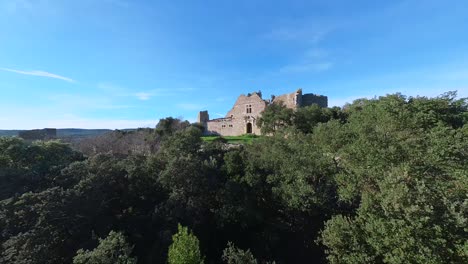 Forest-Canopy-Flight-to-Unveil-a-Ruined-Castle-in-Southern-France