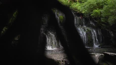 Waterfall-amongst-an-idyllic-forest-with-green-trees-everywhere